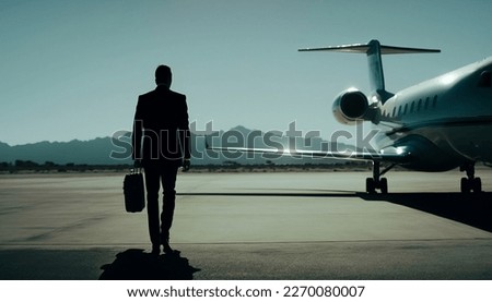 Business man walkikng towards a private jet Royalty-Free Stock Photo #2270080007