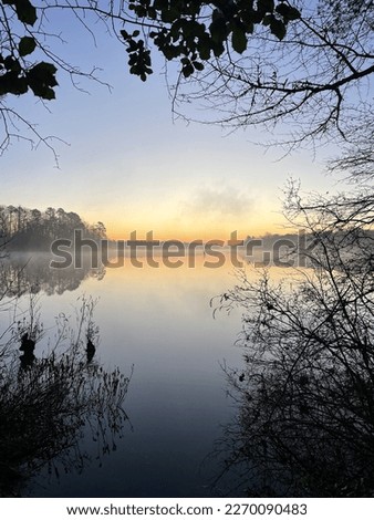 Sunrise over a foggy lake
