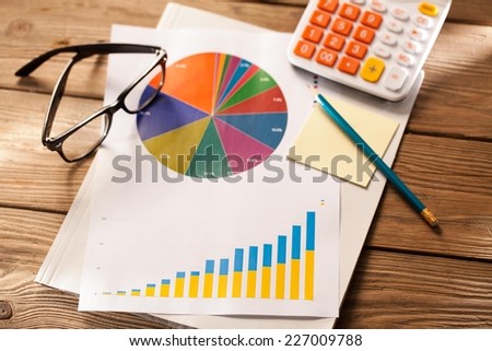 Close up of colorful graphs and calculator.