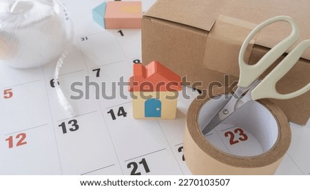 Cardboard boxes and calendars. Image of moving house. Royalty-Free Stock Photo #2270103507