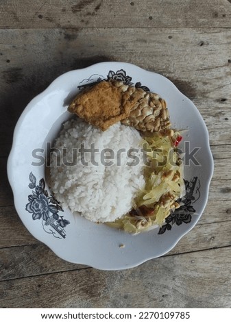 A typical Indonesian house made food. Cheap traditional and common food contains rice, vegetable, (tempe), and omelette of a house restaurant (Warteg or Warung Tegal). Indonesia