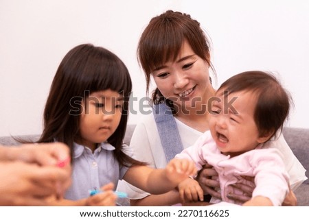 Nursery teacher playing with children