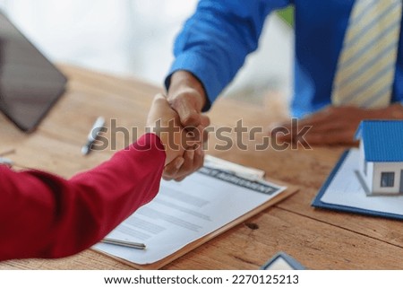 Real estate purchase agreement discussing realtor with customer land and house sale, contract real estate bargains and annual interest rate, Shaking hands Royalty-Free Stock Photo #2270125213