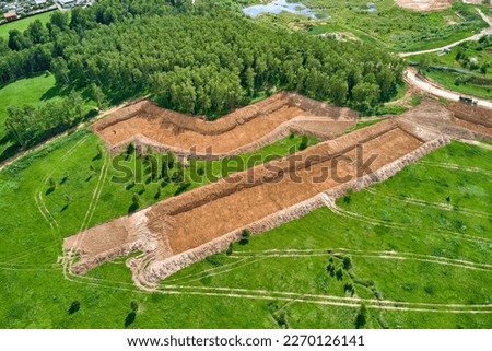 Removal of the top layer of earth overburden for the development of a sand pit, aerial view Royalty-Free Stock Photo #2270126141