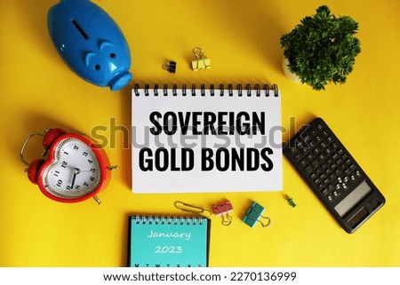 Sovereign gold Bonds Concept on open notepad on office wooden table with different stationery.  Royalty-Free Stock Photo #2270136999