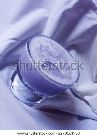Taro milk ice in glass isolated on white background, Taro flavored fresh drink .