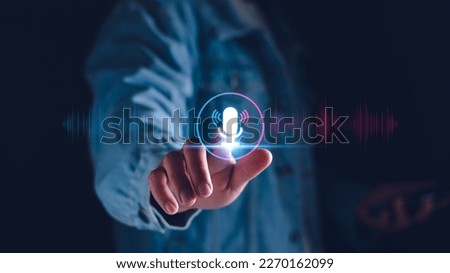 Voice recording. Man touching microphone icon on smart phone. Mobile application Record sound, audio, music, voice message. or Use your voice to direct AI to search for information on Internet. Royalty-Free Stock Photo #2270162099