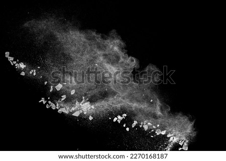 Split debris of  stone exploding with white powder against black background. Royalty-Free Stock Photo #2270168187
