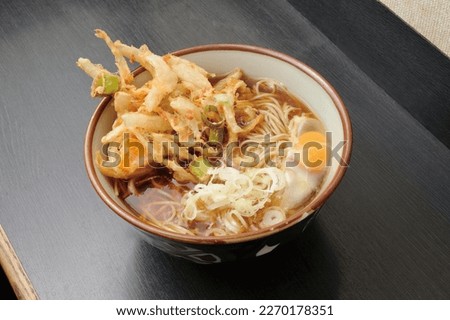 Kakiage soba is a Japanese noodle dish that features a deep-fried vegetable and seafood fritter called kakiage, served on top of a bed of buckwheat noodles (soba) in a hot dashi broth.