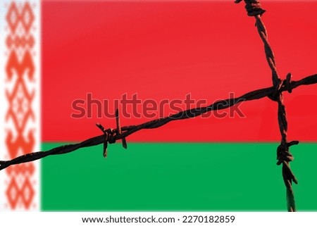 Republic of Belarus flag behind barbed wire fence. Concept of sanctions, embargo, dictatorship, discrimination and violation of human rights and freedom in Republic of Belarus. Closeup