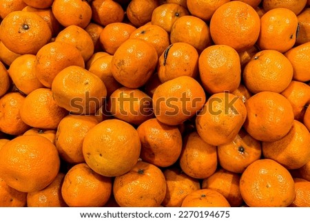 a landscape picture of oranges in a supermarket