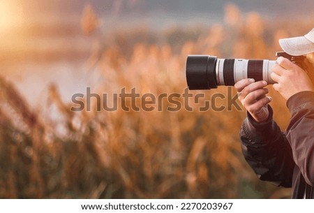 Man taking photo landscape with a big professional camera