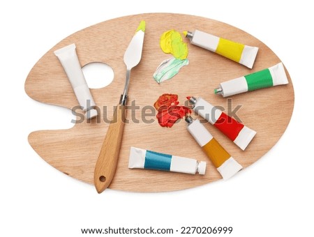 Wooden palette with oil paints and palette knife on white background, top view Royalty-Free Stock Photo #2270206999