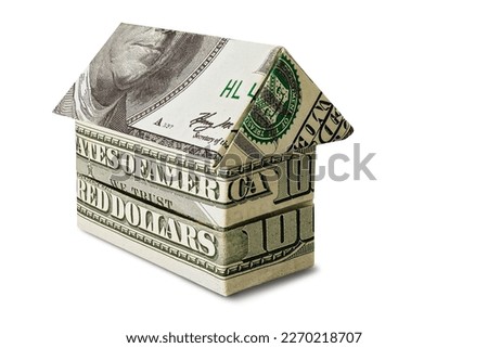 The house is stacked of dollar bills on a white isolated background. Element for design. Buying and selling housing. Mortgage. Property rental. Close-up. Money. Business
