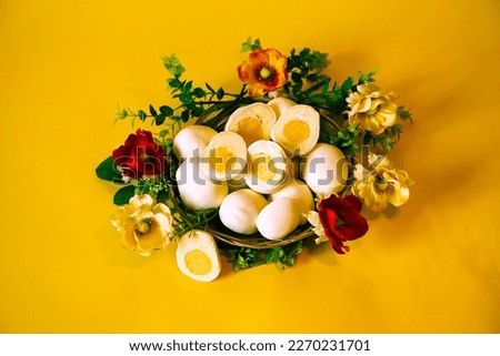Easter picture with handmade Eggs on a yellow background in a basket with flowers. Spring Mood. Baking in the form of Easter Eggs is an interesting alternative to Easter cake. Religious holiday.