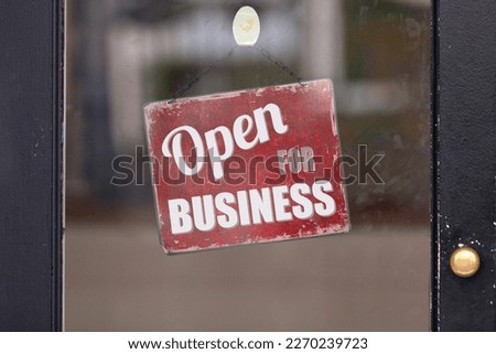 Red open sign with written in it: "Open for Business".