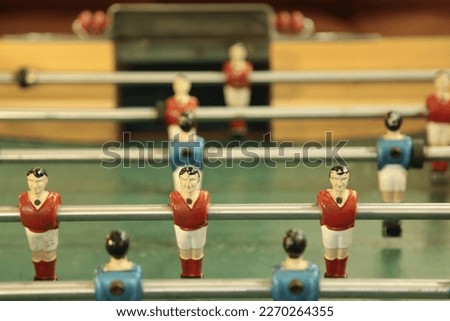 Table football, commonly called fuzboll or foosball (as in the German Fußball "football") and sometimes table soccer, is a table-top game that is loosely based on association football. Royalty-Free Stock Photo #2270264355