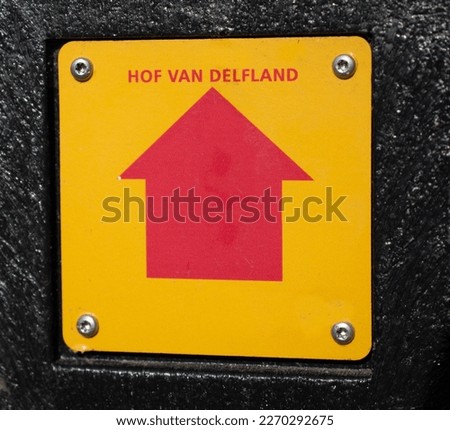Red arrow on a yellow background which leads to a court in Rotterdam. Translation - Court of Delft.