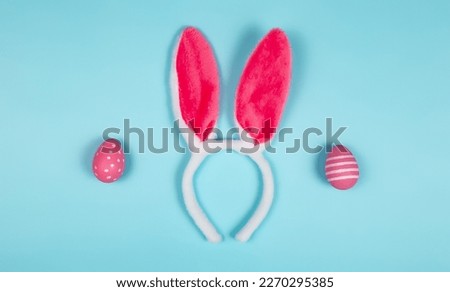 easter holiday background with bunny ears on blue background. copy space