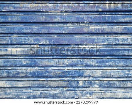 Beautifull and exotic metallic texture in the faded jeans style taken from an aged aluminum gate in a liquor warehouse