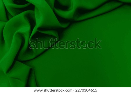 Texture, background, pattern. Texture of green silk fabric. Beautiful emerald green soft silk fabric