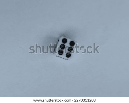 The white dice shows the number six. White color photo background.