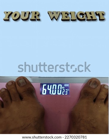 focus on the picture of a pink digital scale with two legs on it. there is also a black alphabet arrangement in a brown box with a blue background