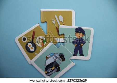Colorful educational puzzle with breakfast food, kitchen utensils, police and police car, placed on a blue background.