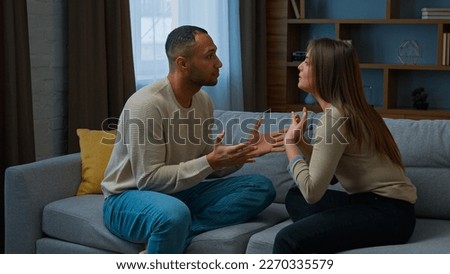 Family conflict couple quarrel annoyed 30s african american man arguing with angry hispanic woman ethnic husband wife talking indoors shouting disagreement problem relationship breakup marriage crisis Royalty-Free Stock Photo #2270335579