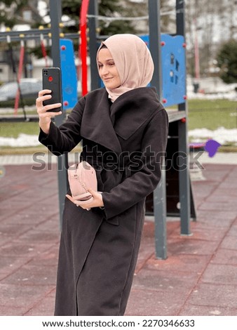 Muslim woman take a selfie in park