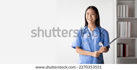 Portrait of female asian doctor standing in her office at clinic.