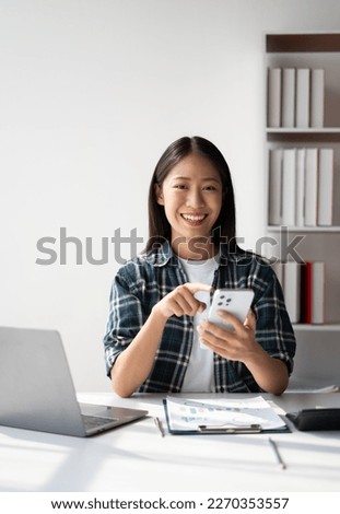 Young asian female student using a smart phone, Creative business woman using smartphone in loft office.
