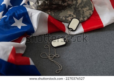 Army tokens on American national flag background.