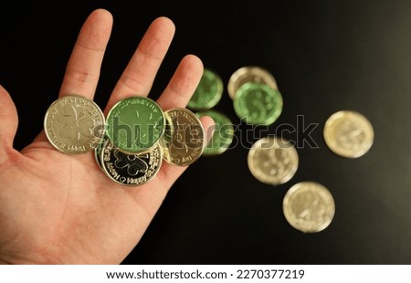 Gold and green coins focused showing money and riches on St. Patrick's Day 