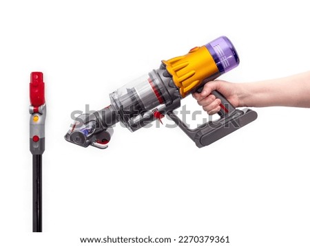 Woman's hand holds Modern cordless vacuum cleaner isolated on white background. New technologies. Royalty-Free Stock Photo #2270379361