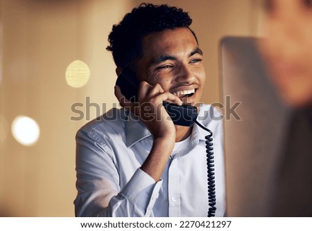 Telephone, night and businessman on a phone call in the office talking while working on a computer. Discussion, communication and professional male employee speaking on a landline in the workplace. Royalty-Free Stock Photo #2270421297