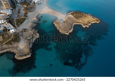 Aerial drone view of the coastline of empty beach in winter. Summer holidays. Nissi beach bay Ayia Napa, Cyprus