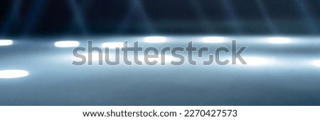 blurred rays of light on the disco floor. white blue neon searchlight lights. laser lines and lighting effect. night empty stage in studio with neon reflections. scene dark abstract background. banner