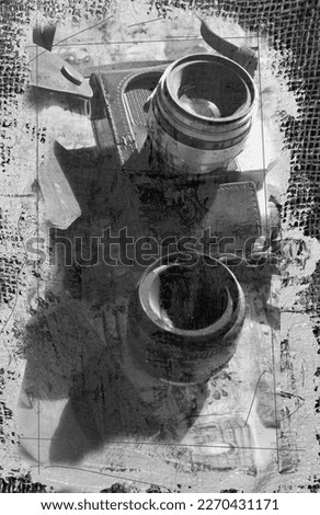 A black and white art canvas depicts a camera with a lens