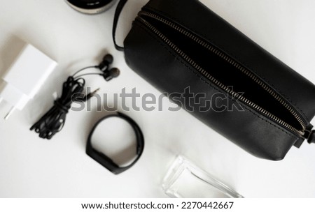 Man's black leather personal cosmetic bag or pouch for toiletry accessory. Style, retro, fashion, vintage and elegance. Royalty-Free Stock Photo #2270442667