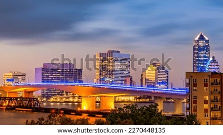 Long exposure of Jacksonville, Florida skyline and Acosta bridge spanning St. Johns river, at dusk. Jacksonville is a city located on the Atlantic coast of northeastern Florida.