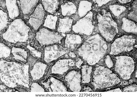 Cobblestone tiles street with big stones, top view. Ancient stone floor texture. Old pavement for a poster, calendar, post, screensaver, wallpaper, postcard, cover, website. High quality photography