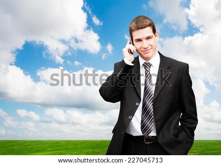 Young successful businessman smiling while talking on the phone.