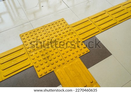 Pedestrian paths, Braille blocks in tactile paving for the blind handicapped in tiled pathways, paths for the blind.