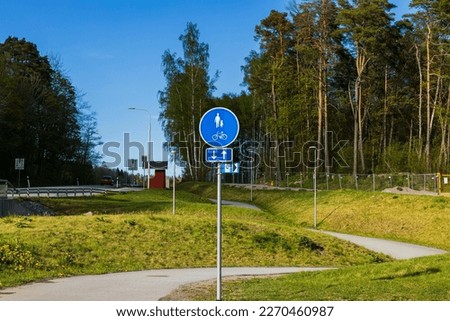 Beautiful view of highway with suburb road with sign of pass for walking and bicycles. Sweden. Europe.