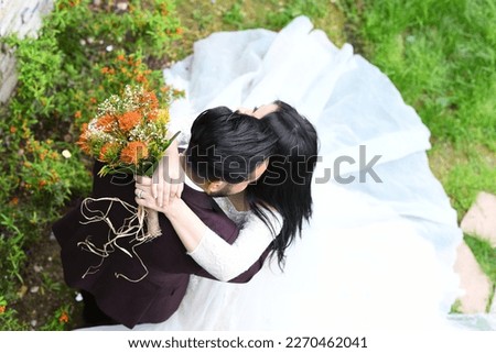 Wedding couple hugging for the cameras for theşr wedding picture book.