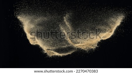 Sand flying explosion, Golden sand wave explode. Abstract sands cloud fly. Yellow colored sand splash throwing in Air. black background Isolated high speed shutter, throwing freeze stop motion Royalty-Free Stock Photo #2270470383