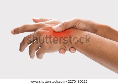 A man grab hand palm because the hand palm was injured. Hand pain. On a gray background.