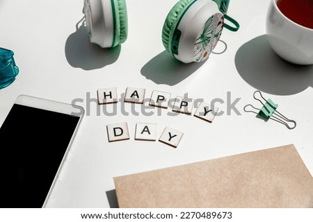 'happy day' wording and metal paper clips isolated over white background, business concept, memory reminder paper, work or educational tools. High quality photo