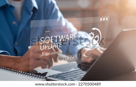 Man working and installing update process. Software updates or operating system upgrades to keep your device up to date with enhanced functionality in new versions and improved security. Royalty-Free Stock Photo #2270500489